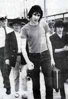 Pete Townshend escorted by air marshall